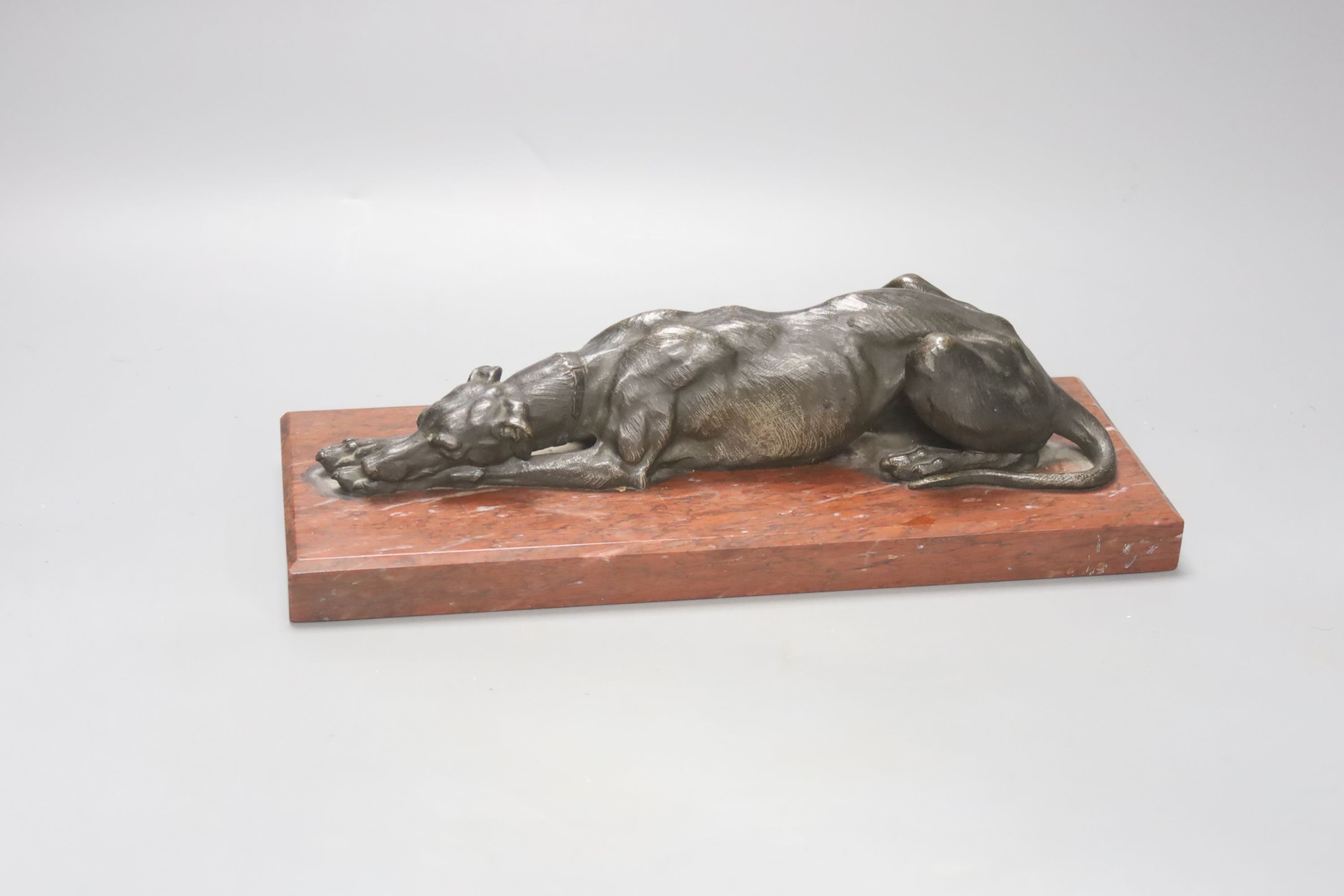 Animalier School, A 19th century bronze figure of a recumbent greyhound, on marble base, length 27cm